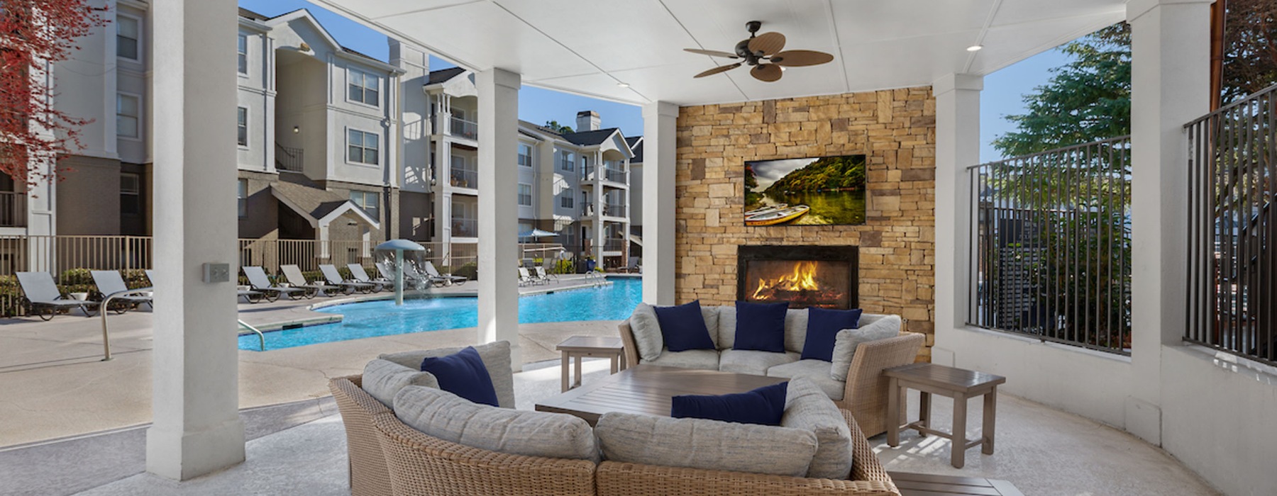 outdoor lounge with fireplace and television