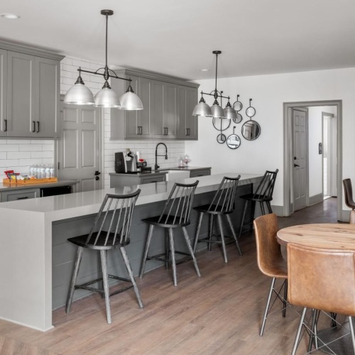 The essence of exceptional living a clubhouse kitchen with grey cabinets and open seating