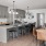 a clubhouse kitchen with grey cabinets and open seating