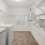 large closet with shelves and washer, dryer set up