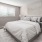 a bedroom with a bed and lamps